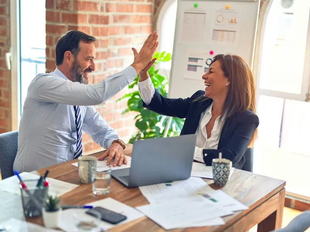 Professionals talking through a plan at an office table